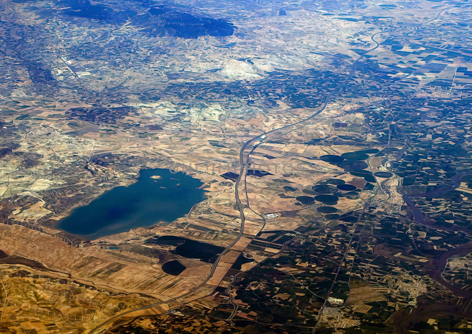 Top view of the ground from the plane. European landscape. Colorful pattern of trees, fields, rivers and lakes. by bonilook