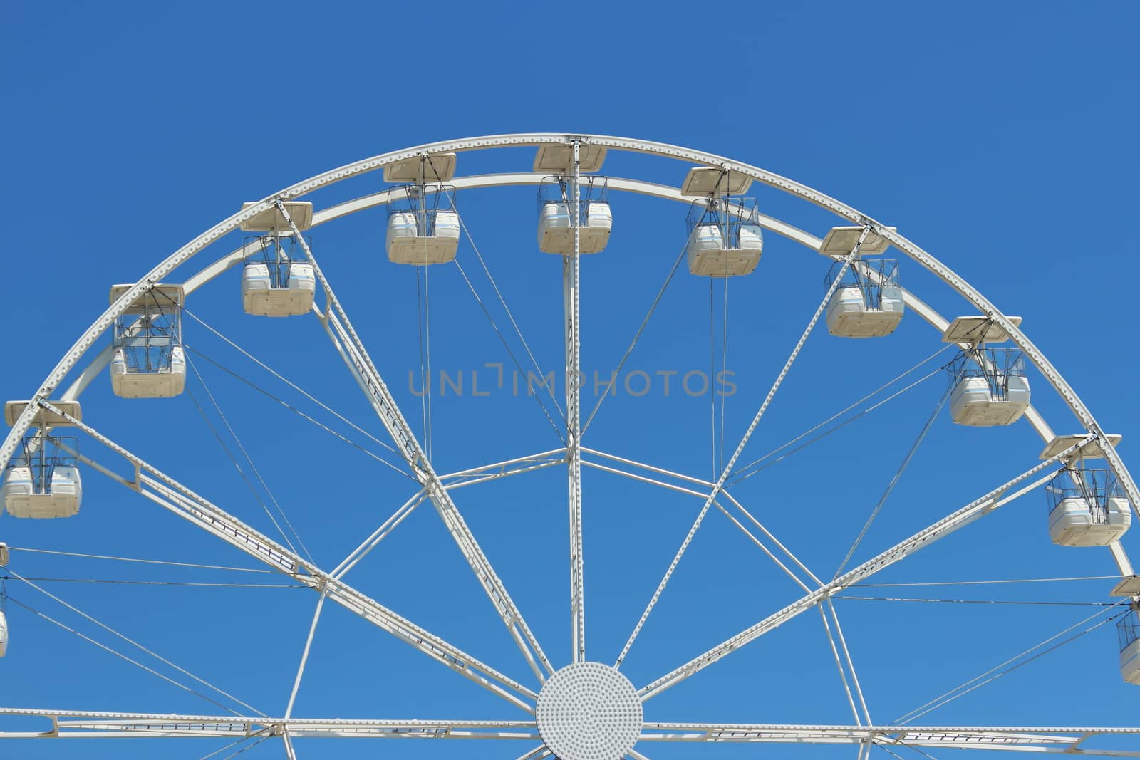 fun for children.Big ferris wheel with the blue sky in the background