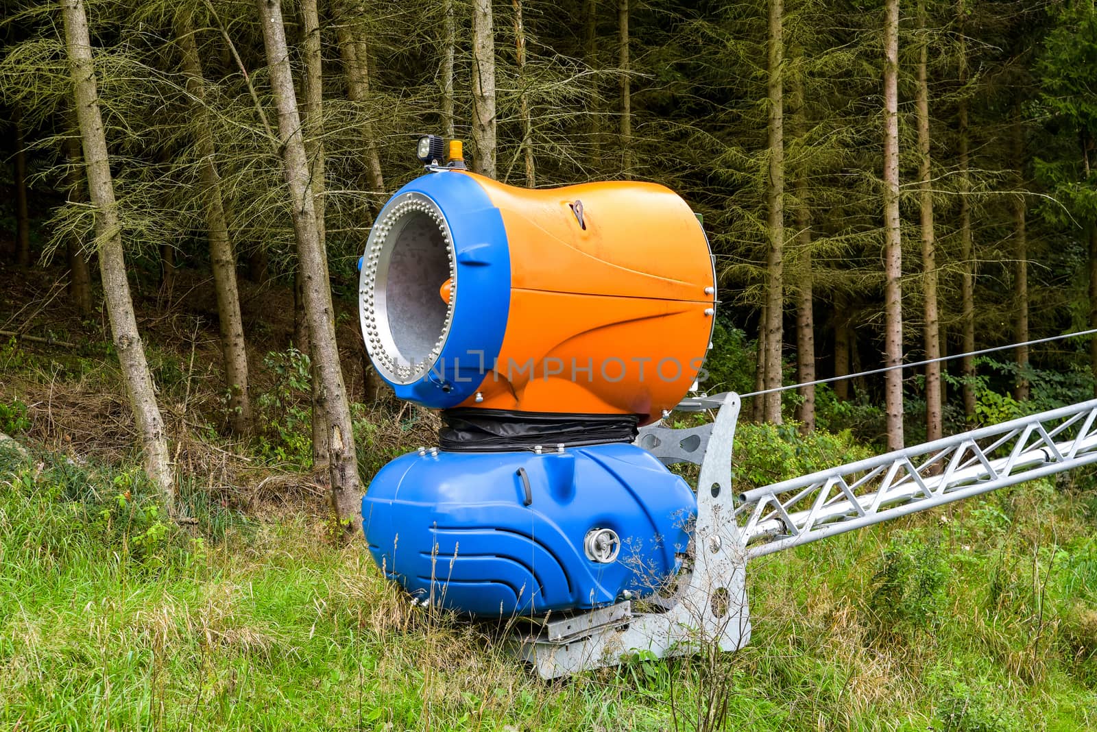 Snow blowing machines or snow cannons making snow