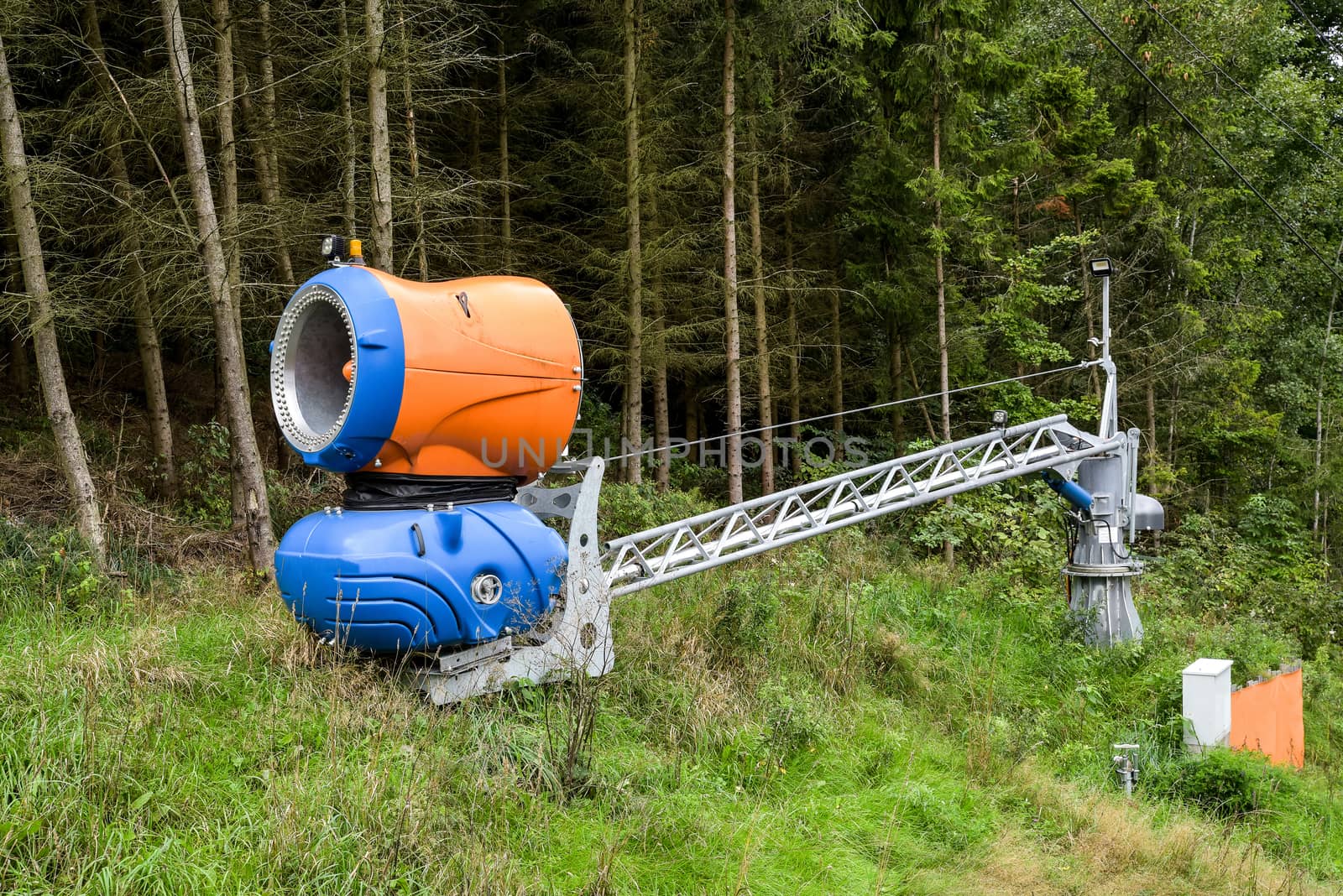 Snow blowing machines or snow cannons making snow