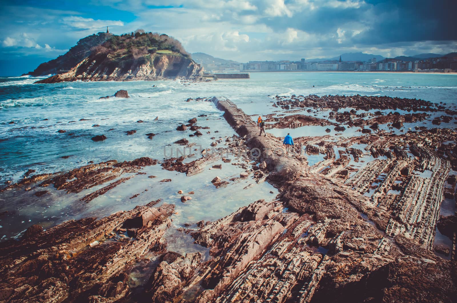 Rock formations on the seabed with Santa Clara island and San Sebastian at the background, Spain by mikelju