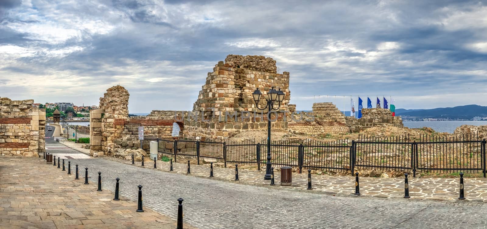 Nessebar, Bulgaria – 07.10.2019.  Ruins of ancient fortifications at the entrance to the Old Town of Nessebar, Bulgaria, on a cloudy summer morning