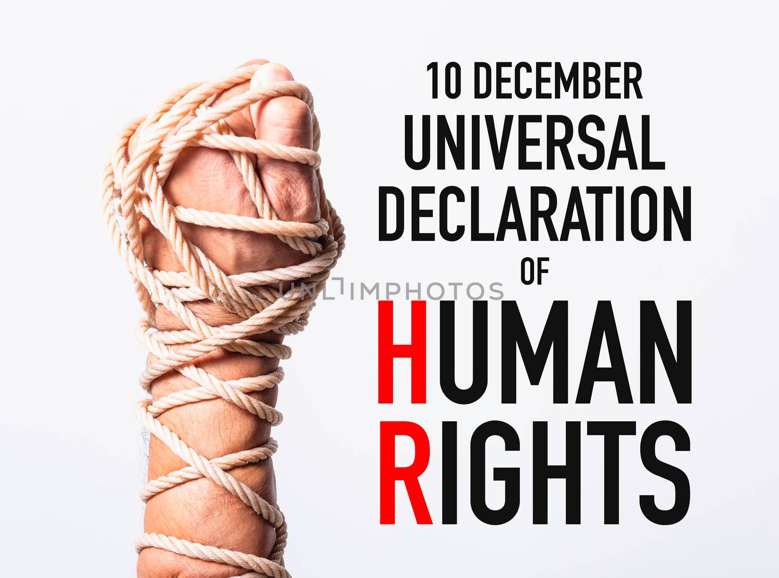 Rope on fist hand with 10 december universal declaration of HUMAN RIGHTS DAY text on white background, Human rights day concept