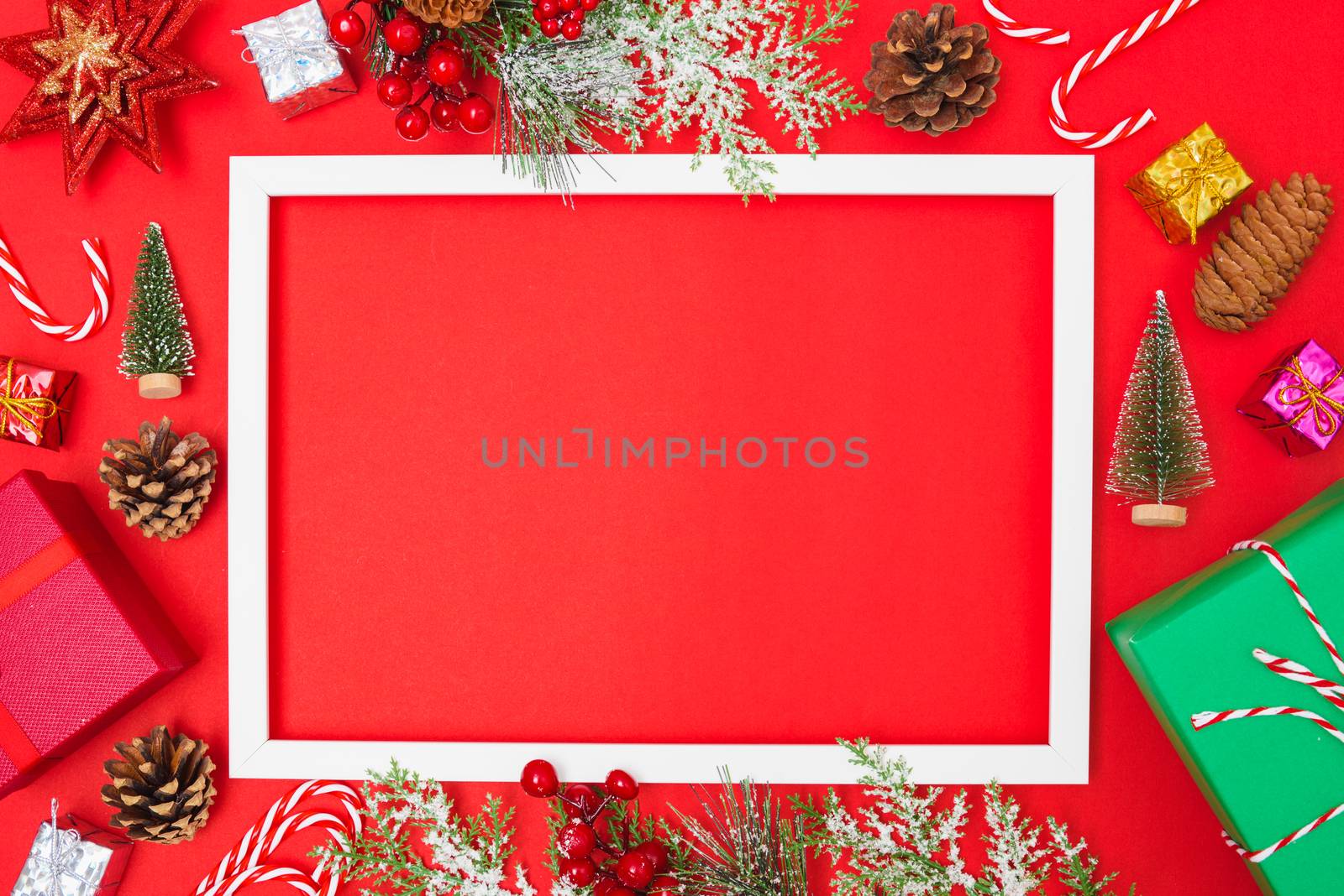 Christmas composition decorations, fir tree branches with Photo square frame on red background. Merry Christmas concept. Copy space for text