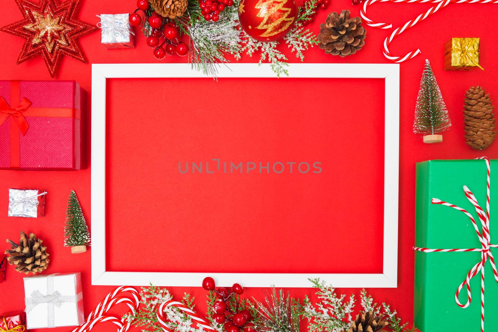 Christmas composition decorations, fir tree branches with Photo square frame on red background. Merry Christmas concept. Copy space for text