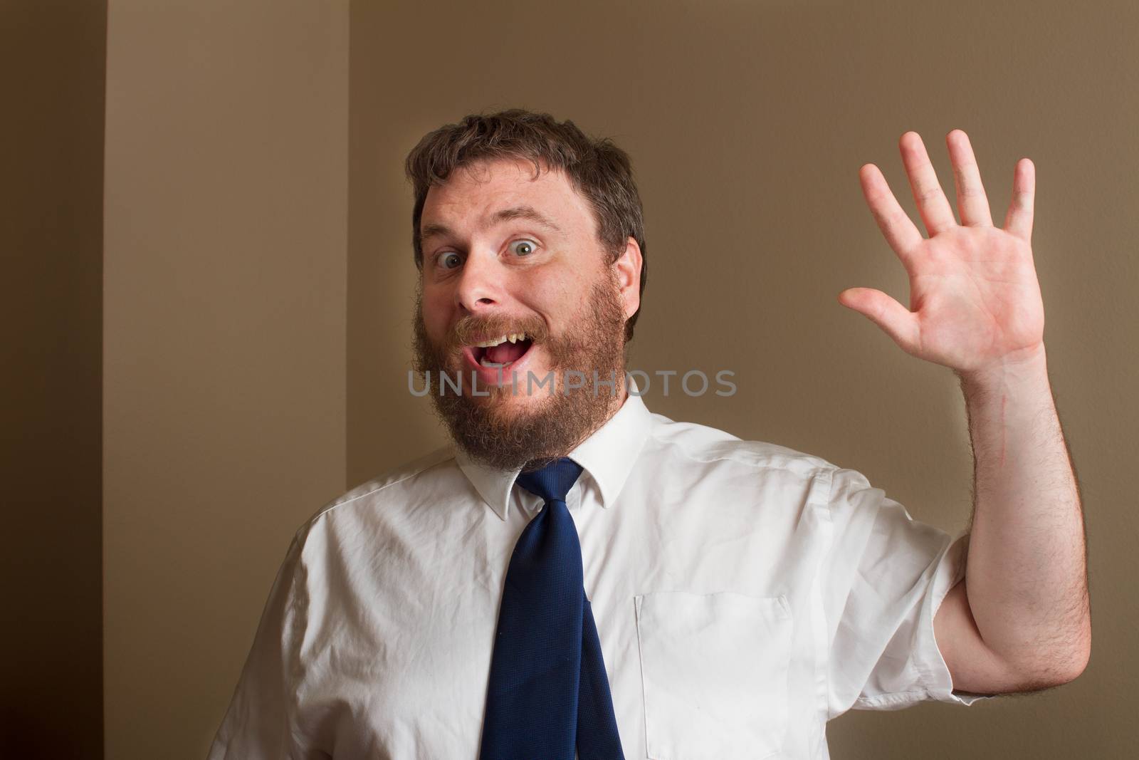 man has his hand up to wave at you