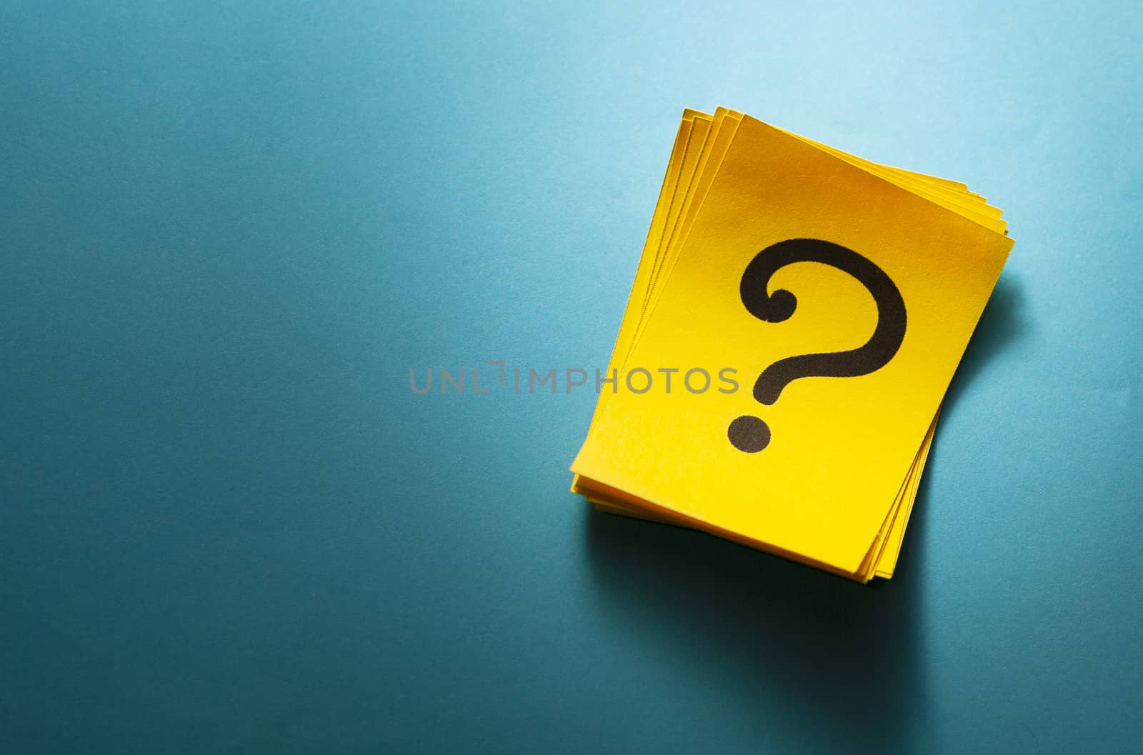 Stack of colorful yellow cards with question mark by sergii_gnatiuk