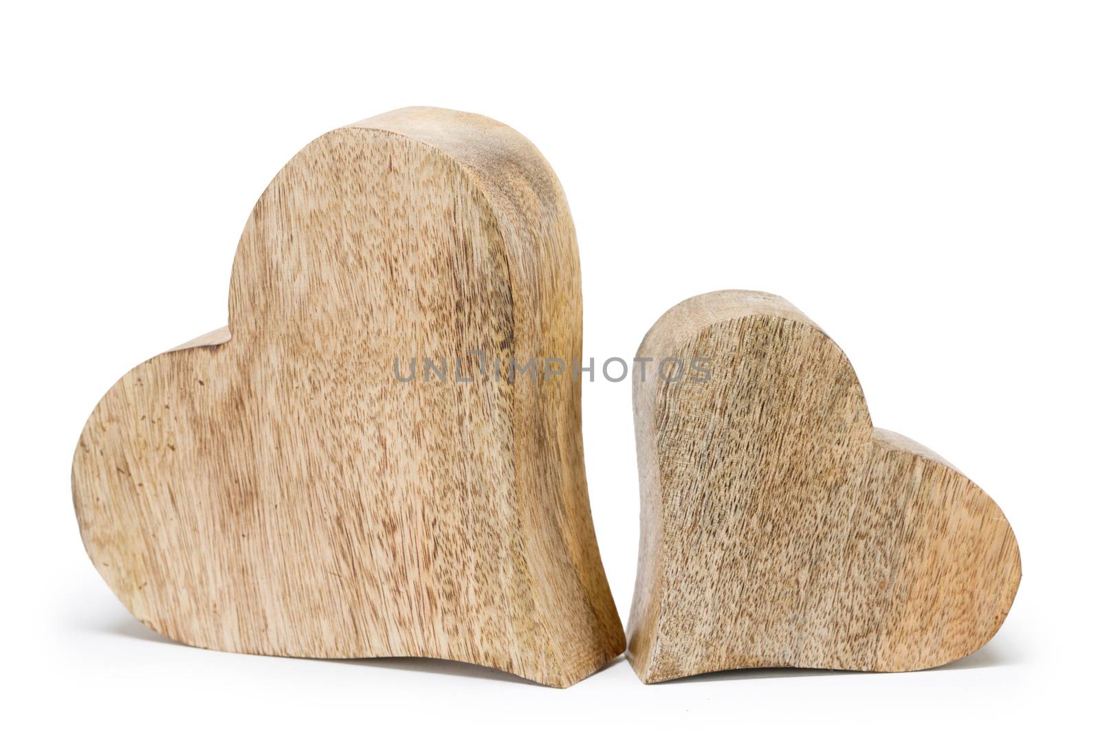 Two handmade wooden carved hearts isolated on white background couple relationship Valentine day concept