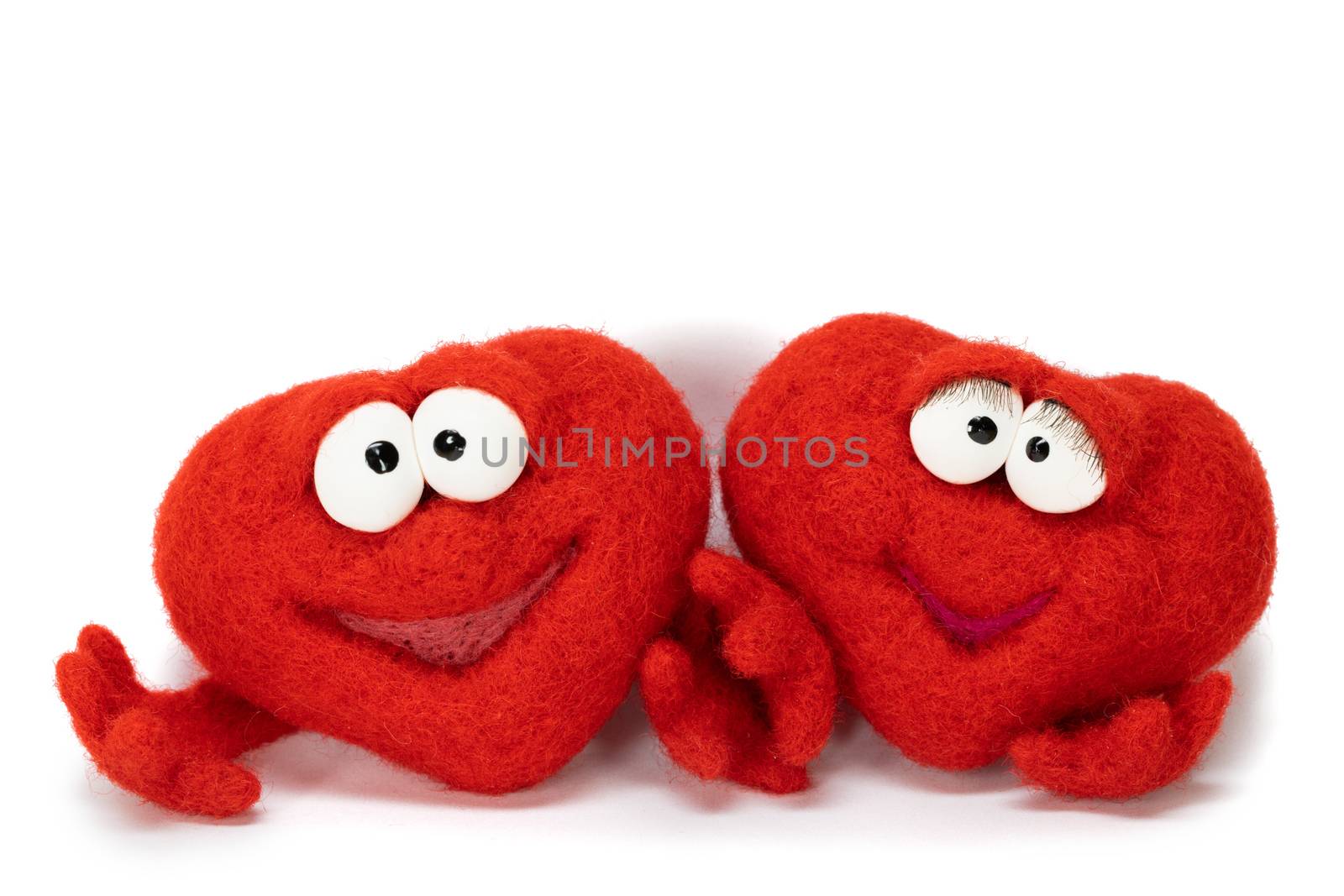 Two wool red hearts isolated on white background, symbol of love, healtcare, valentines day concept