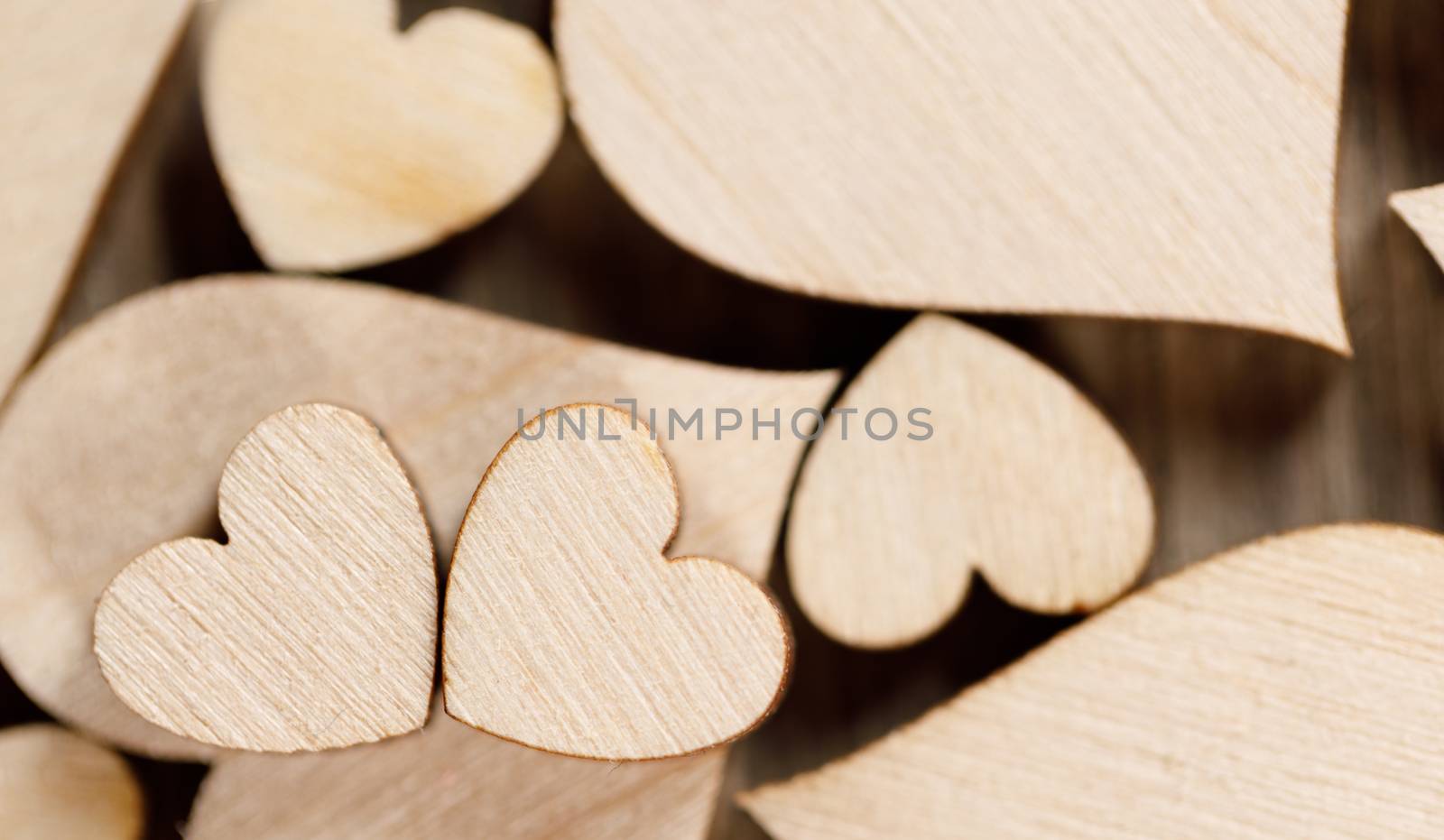 Many wooden colorless hearts background