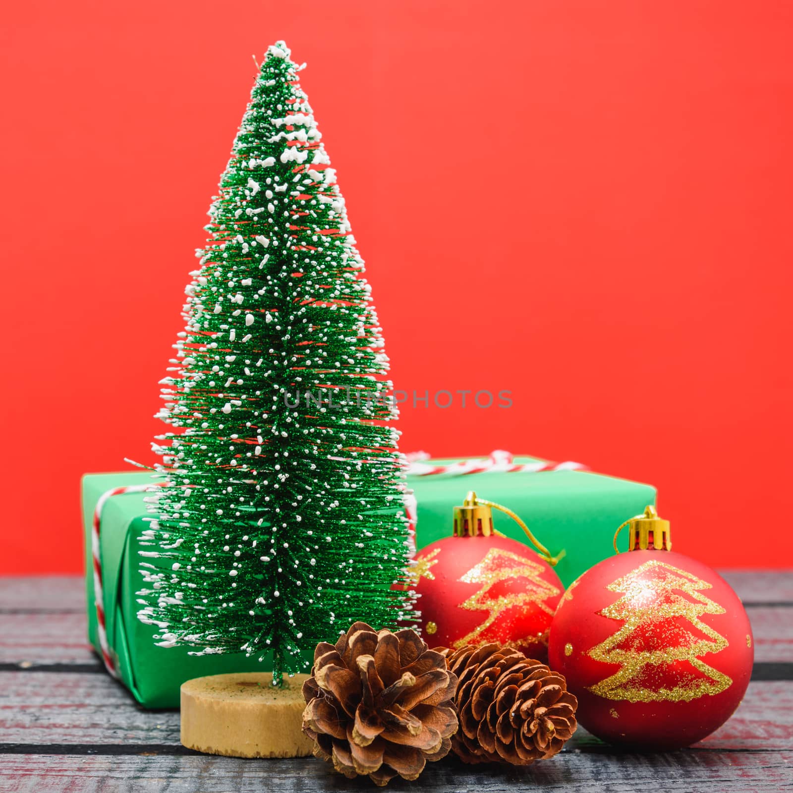 Christmas composition and decorations, minimal green fir tree branches with snow on red background. Merry Christmas concept. Copy space for text