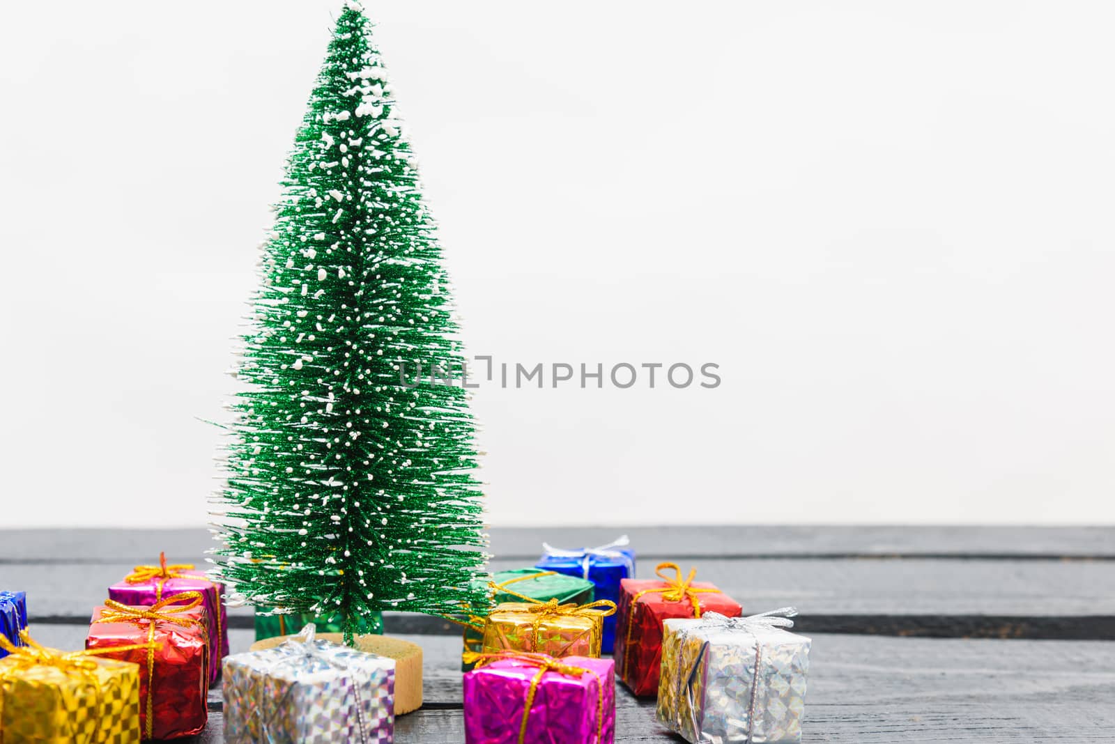 Christmas composition decorations, minimal green fir tree branches with snow and gift boxs on white background. Merry Christmas concept. Copy space for text