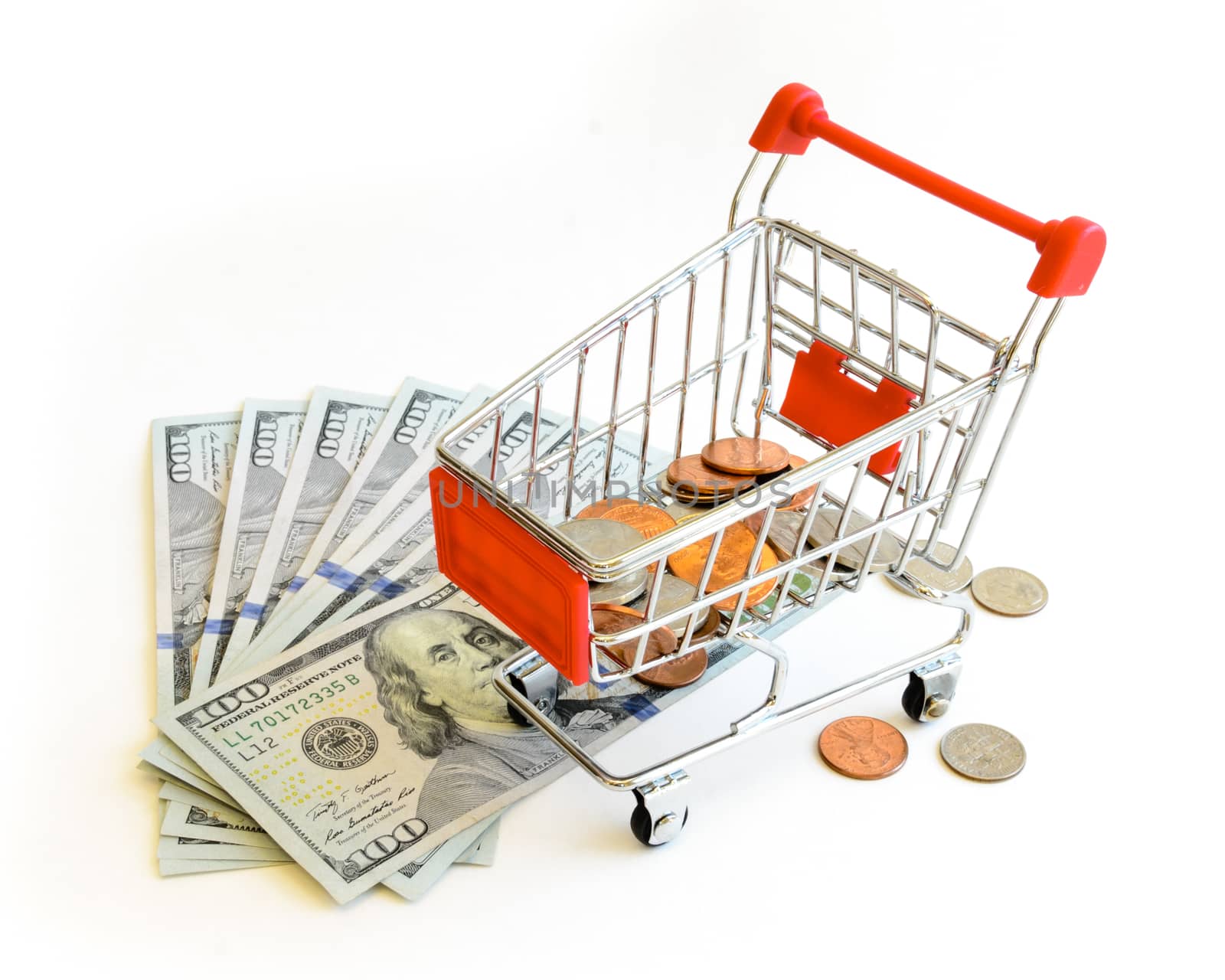 US dollars banknote and coins with shopping cart isolated on white background. Concept of currency, business, finance and online shopping or e-commerce.