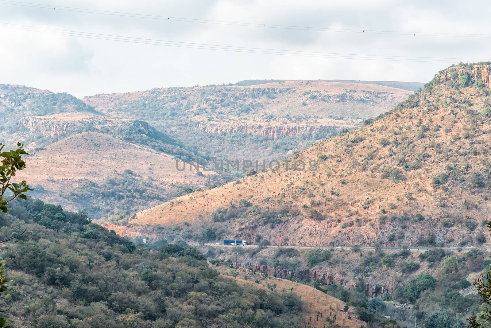 The Elands River Pass at Waterval Boven in Mpumalanga. Vehicles and a power transmission line are visible