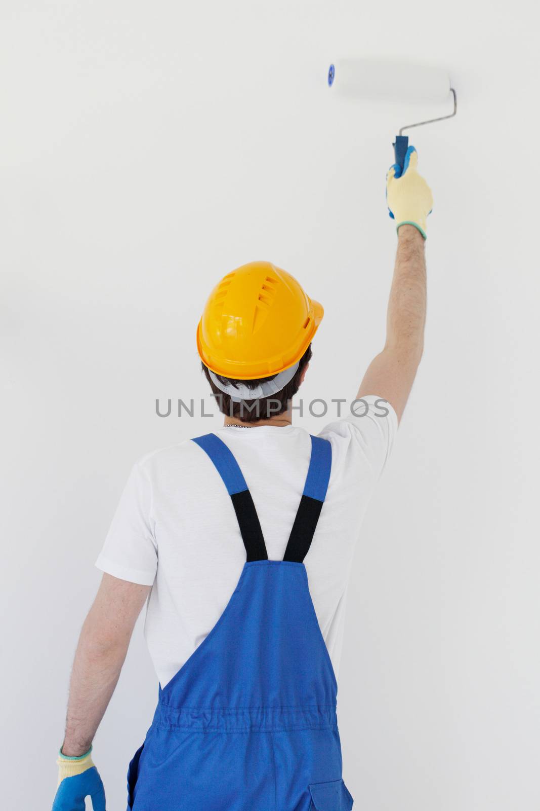 Worker painting walls in new house by ALotOfPeople