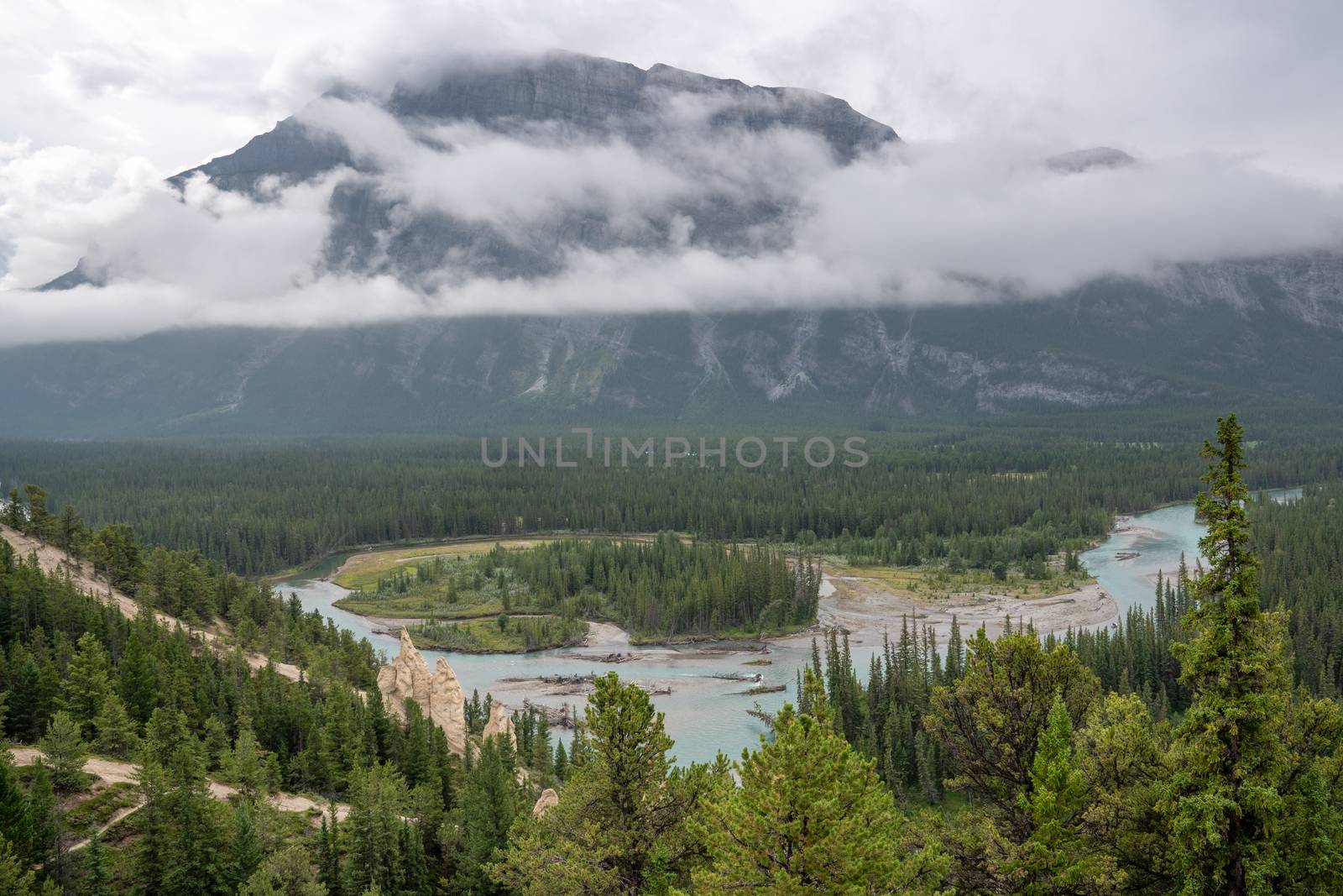 Panoramic image of the Hoodoos close to Banff with the Bow river and the Mount Rundle under clowds in the background, Banff National Park, Alberta, Canada