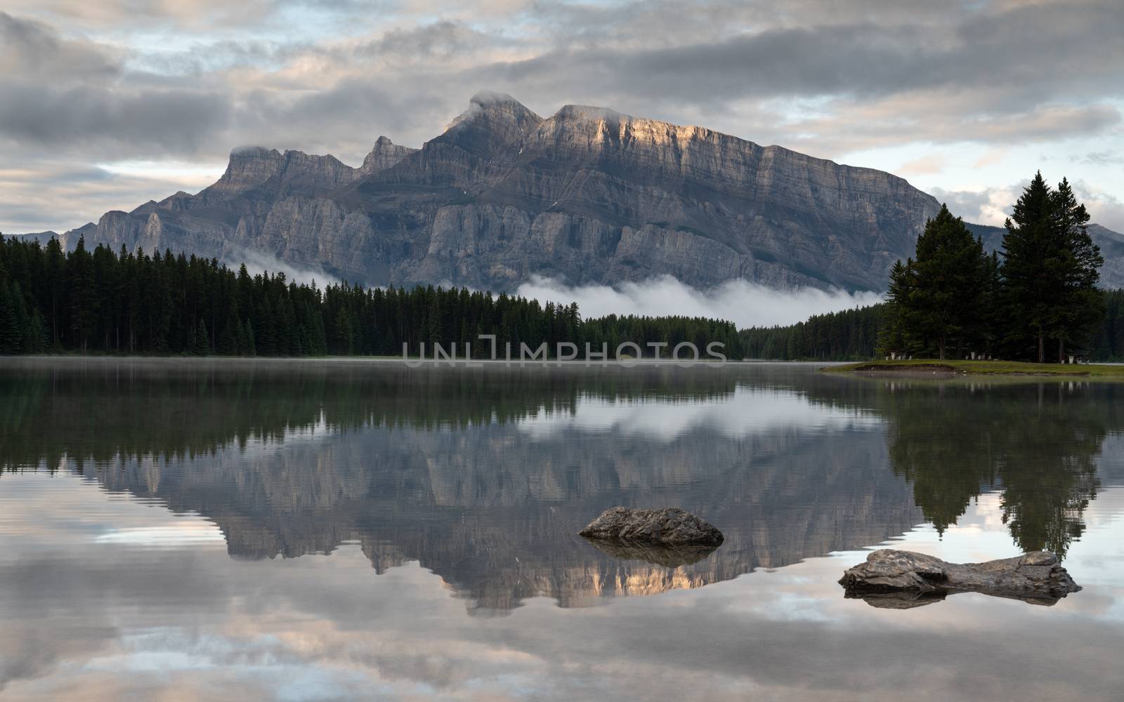 Panoramic image of Mount Rundle reflecting in Two Jack Lake with early morning mood, Banff National Park, Alberta, Canada
