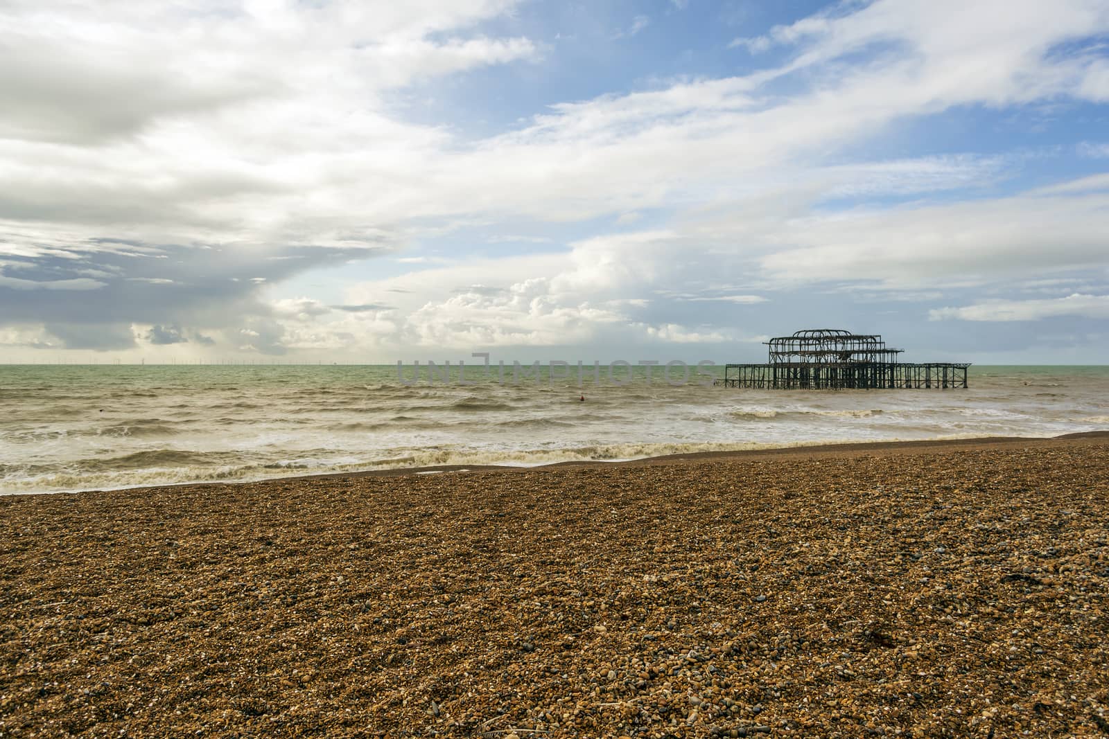 Panoramic view of Brighton's beach. In the background they are the remains of Brighton West Pier in sea. by ankarb