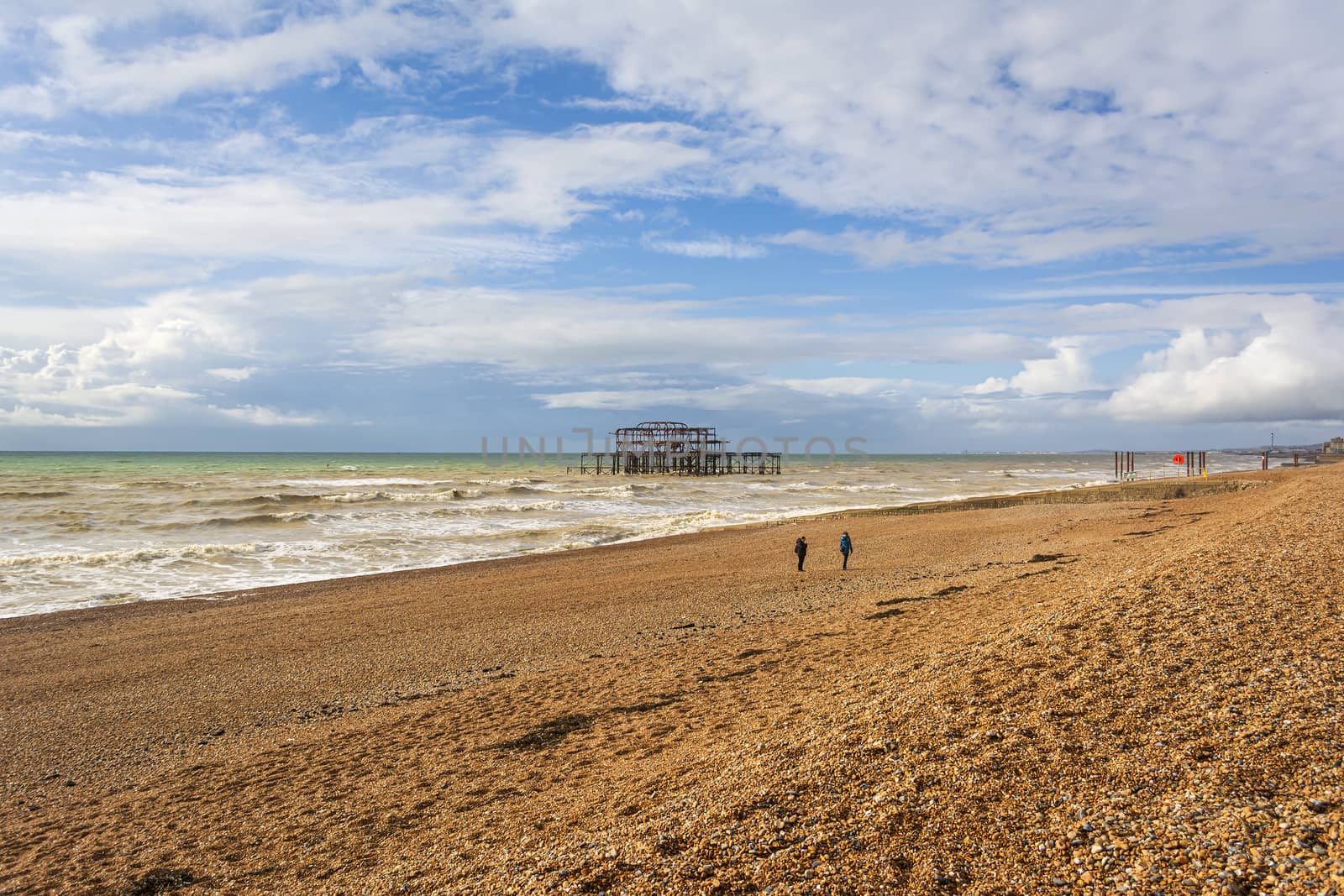 Panoramic view of Brighton's beach. In the background they are the remains of Brighton West Pier in sea. by ankarb