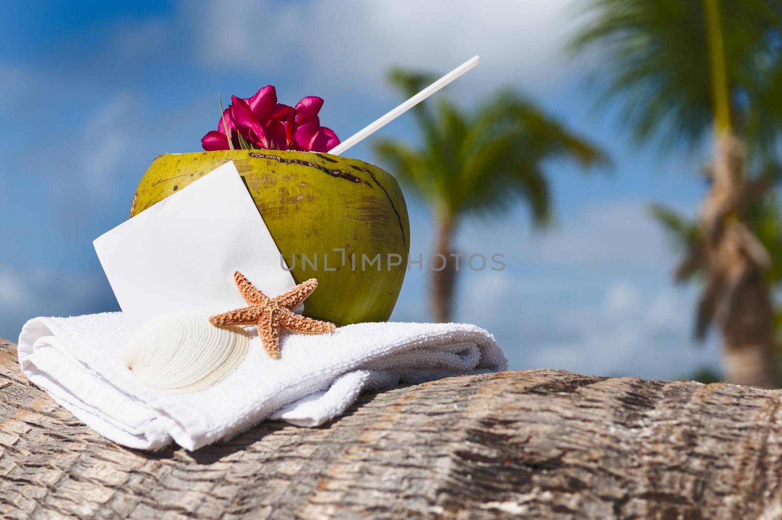 Coconut cocktail starfish tropical Caribbean beach refreshment and towel