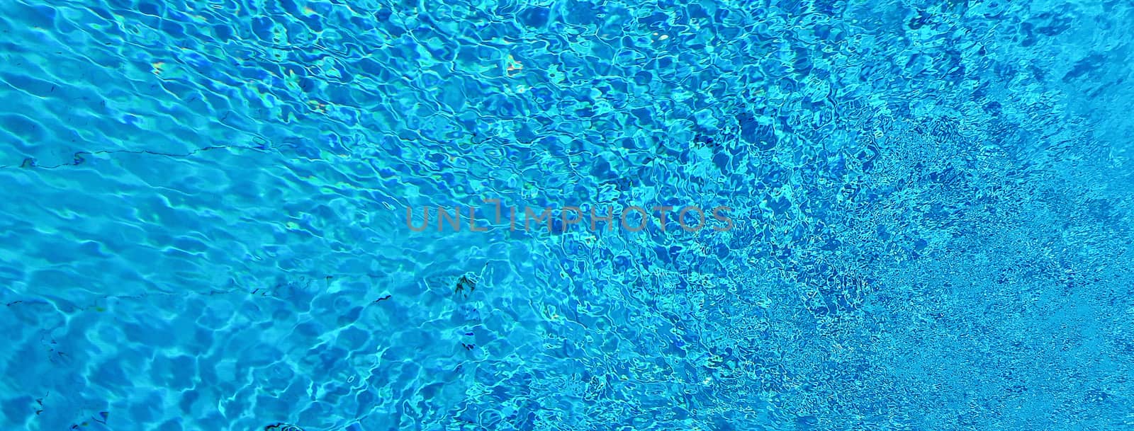Blue water surface and ripple wave in swimming pool by marcorubino