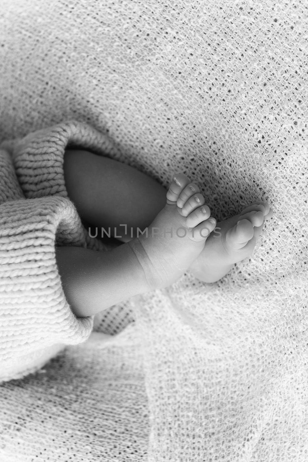 Closeup of a newborn baby feet by marcorubino