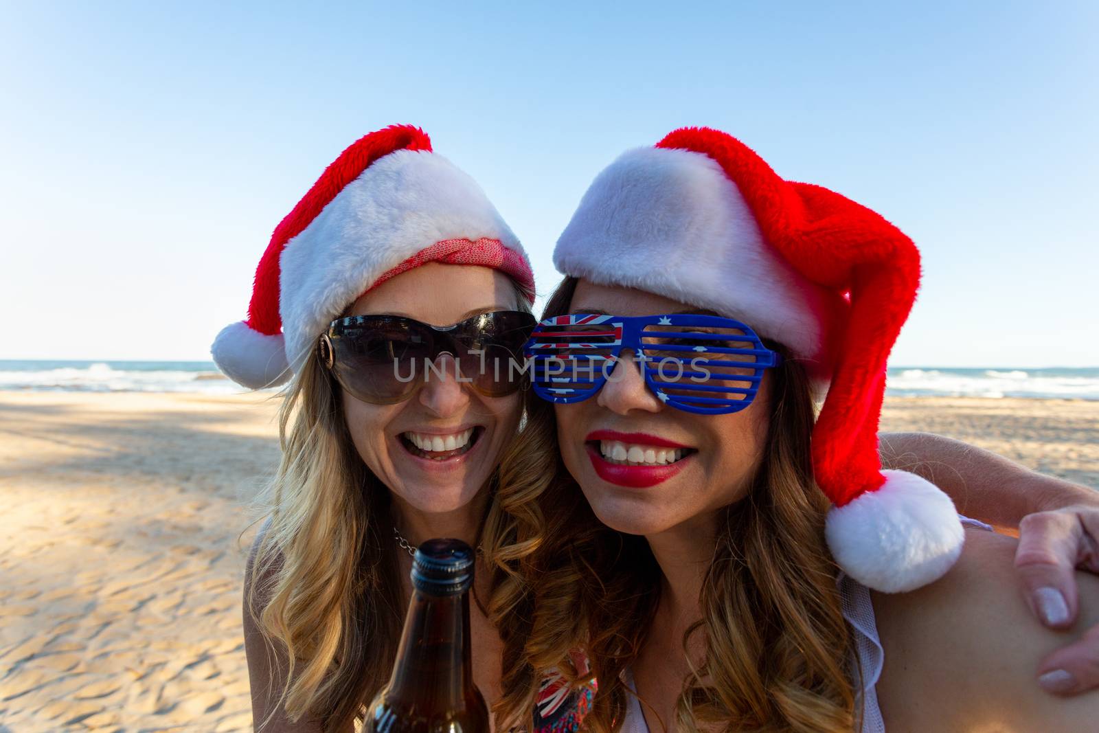 Australian women having fun at Christmas time down on the beach on a relaxed and casual  summer day
