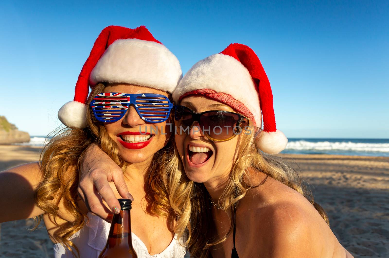 Australians reveling on beach at Christmas time by lovleah