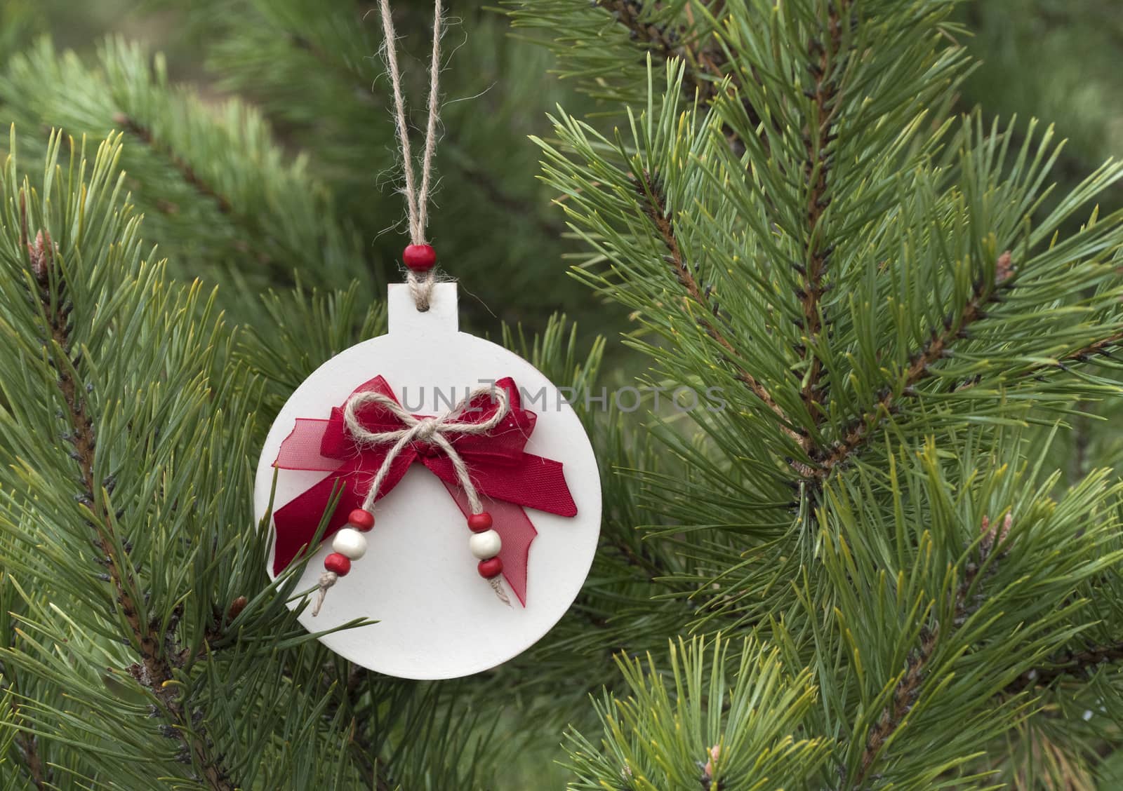 Homemade wooden Christmas decorations for the Christmas tree. Traditional christmas hand made decoration hanging on fir tree.
