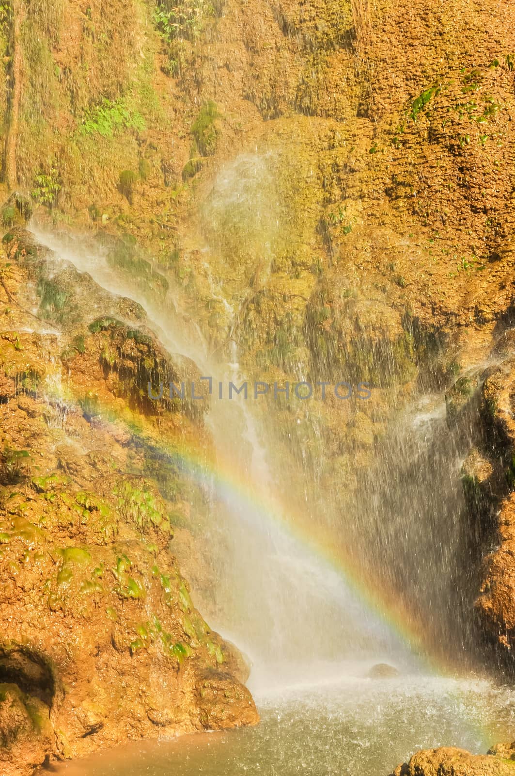 Refreshing waterfall pouring into an emerald pond and rainbow over Dai Yem (Pink Blouse) by trongnguyen