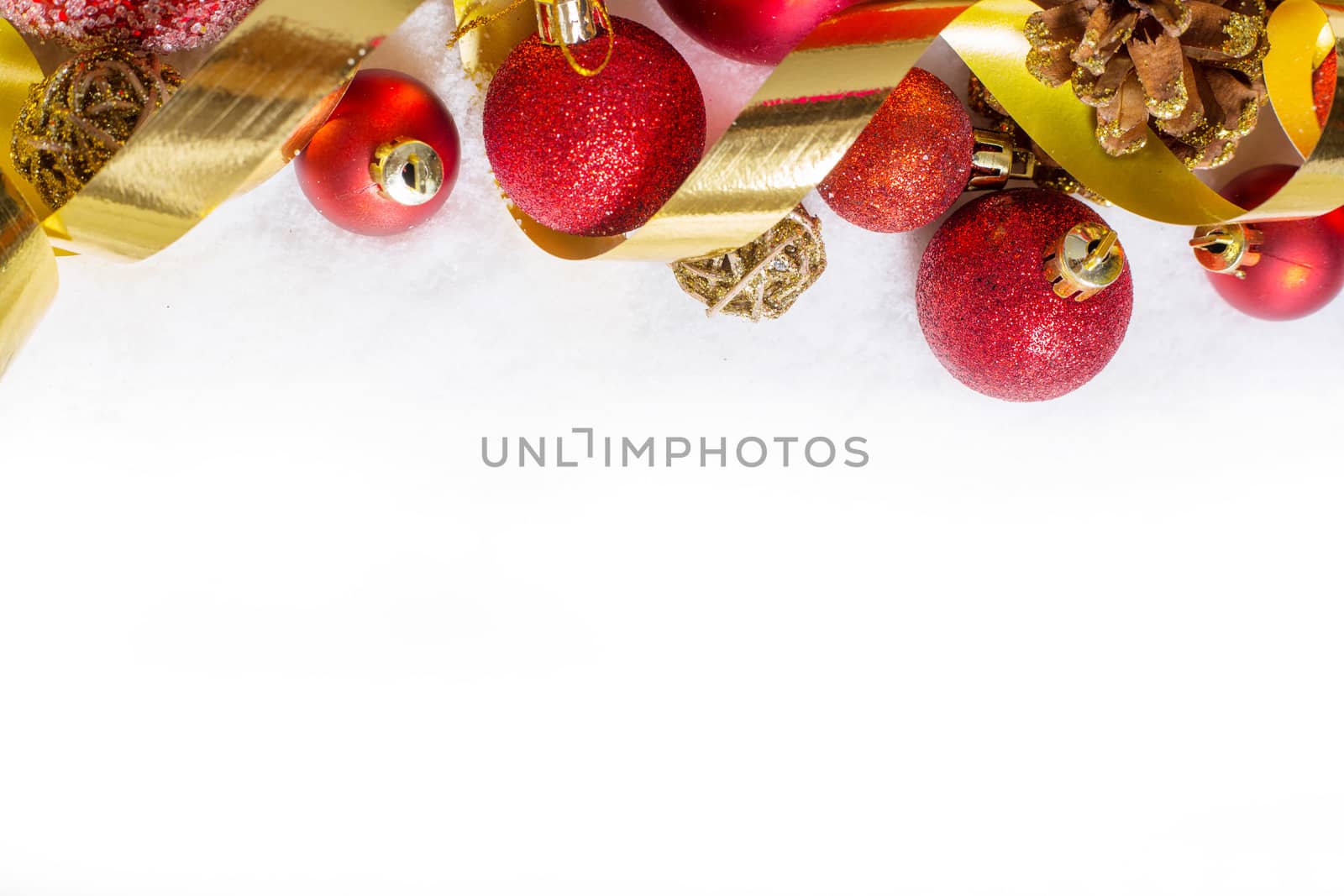 Christmas red balls on snow over white background with copy space for text