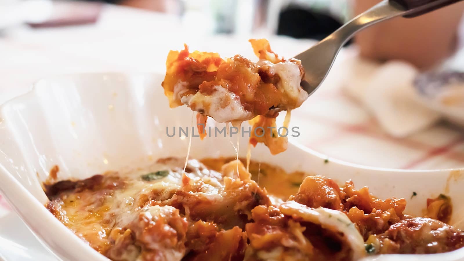 Delicious lasagna recipe - people with famous Italian food concept