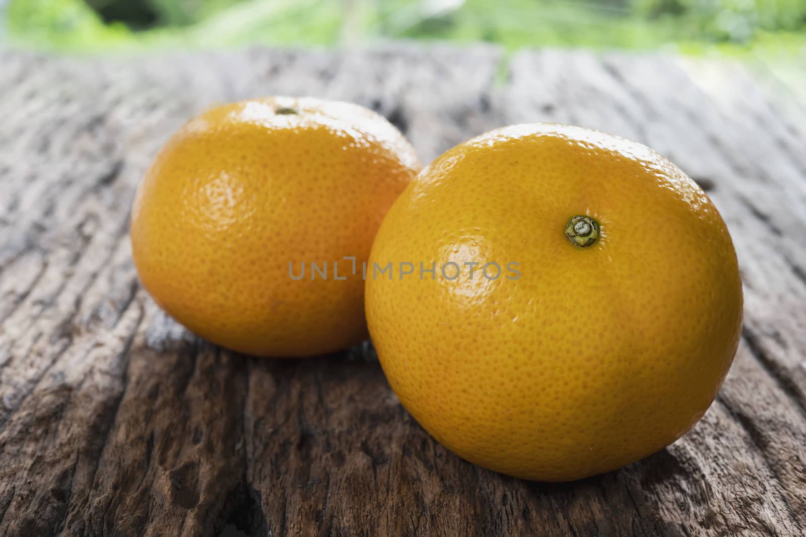 Fresh juicy orange fruit set on old wooden texture plank - tropical orange fruit for background use by pairhandmade