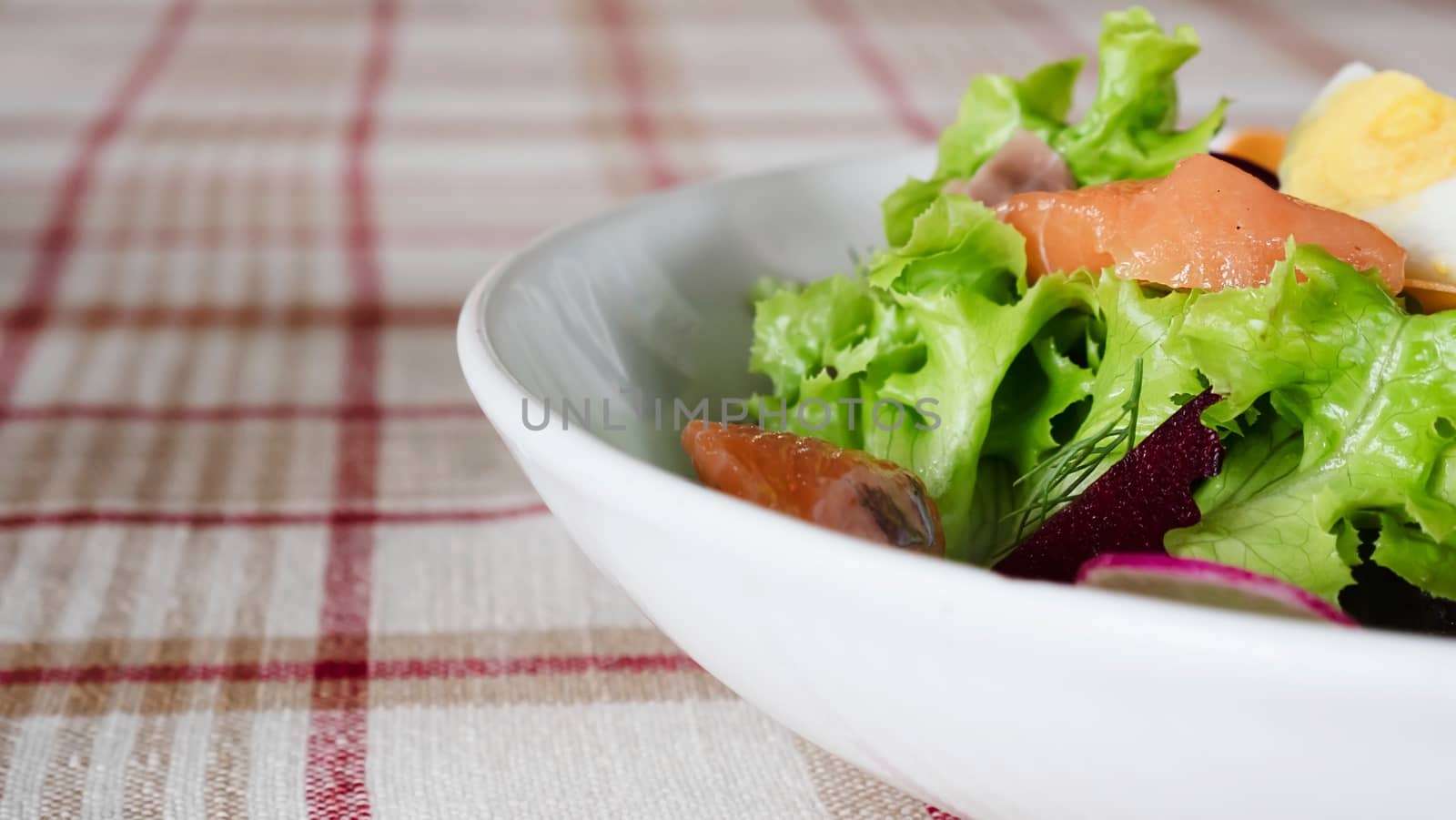 Fresh salmon vegetable healthy salad on white plate ready for eating - fresh clean healthy food recipe for background use