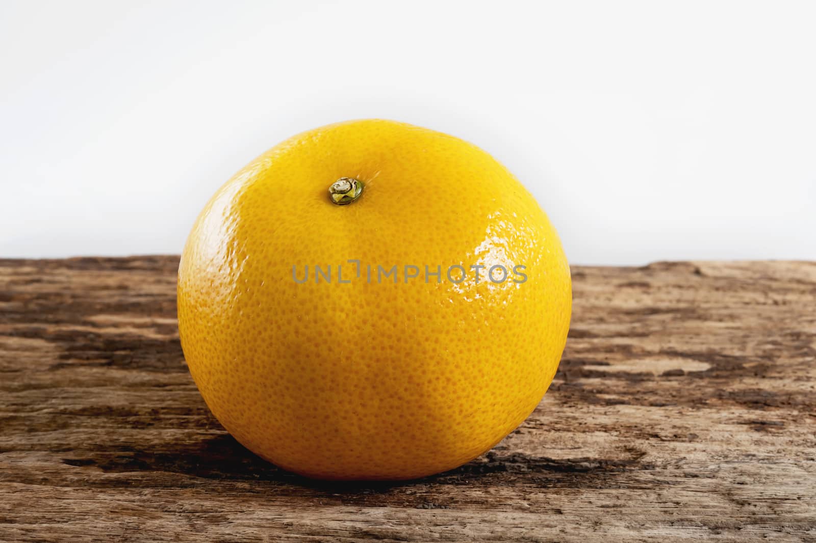 Fresh juicy orange fruit set on old wooden texture plank - tropical orange fruit for background use