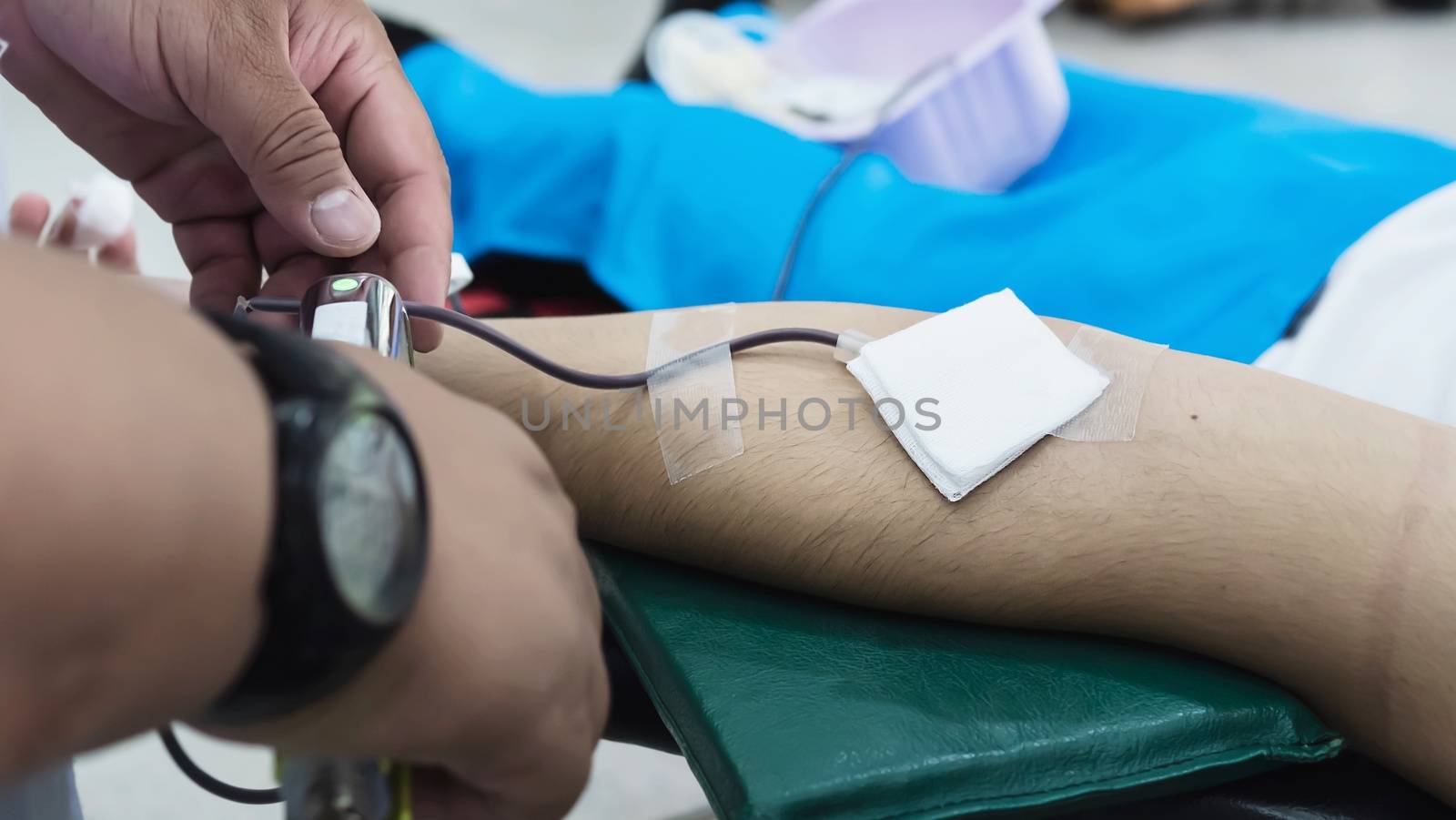 Volunteer man giving blood donation to cross red organisation - people with blood donation concept
