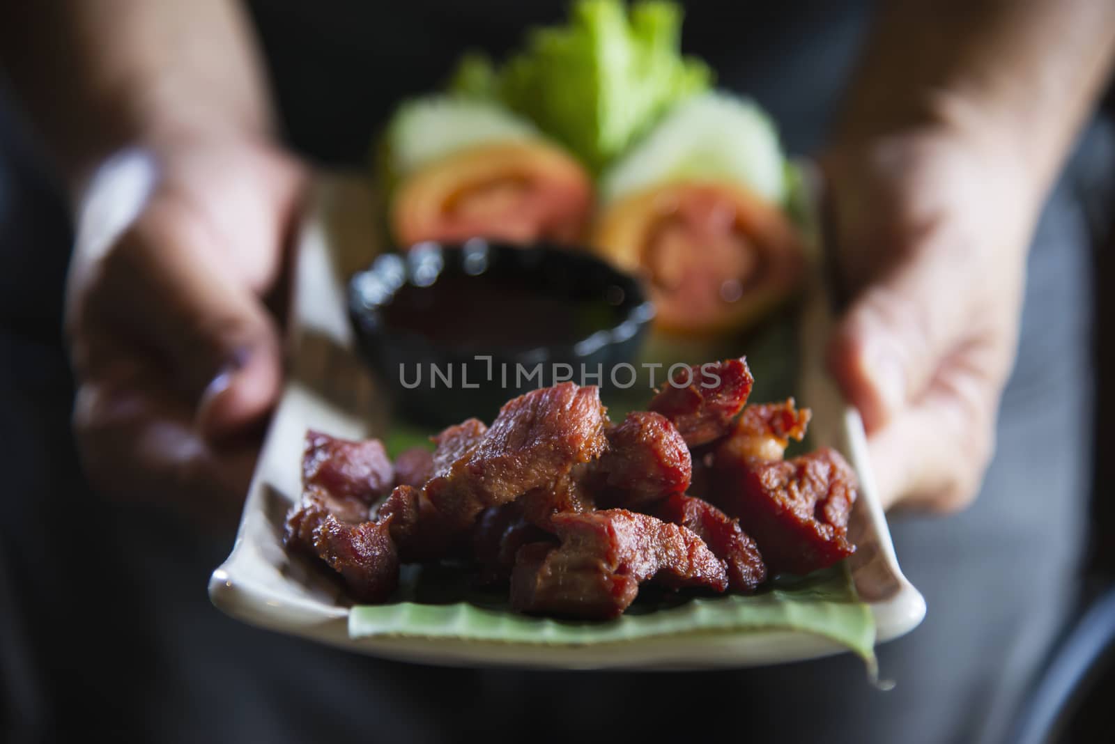 Man serving fried pork recipe - Norther Thai local tradition famous food