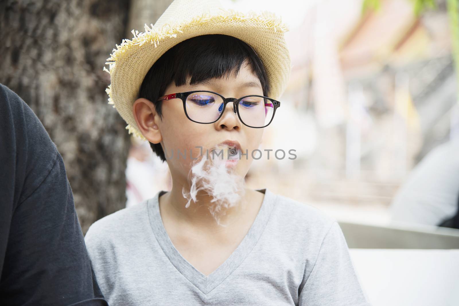 Asian boy eating smoking canny happily - people and snack happy time concept