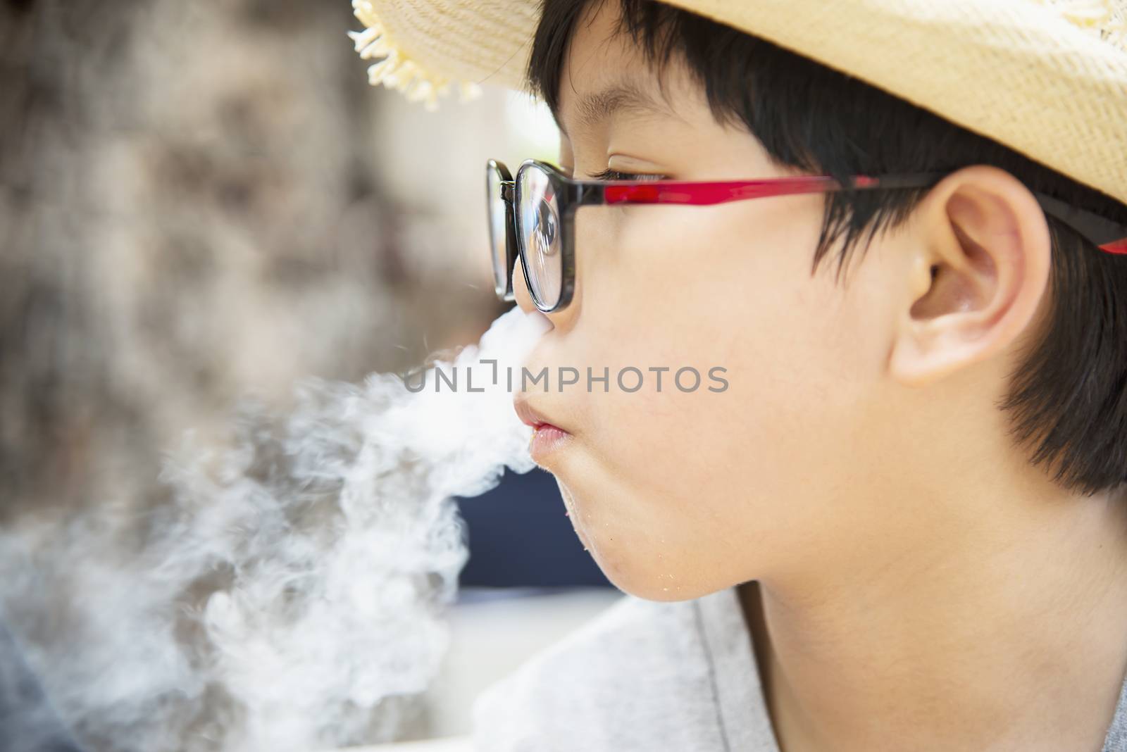 Asian boy eating smoking canny happily - people and snack happy time concept by pairhandmade
