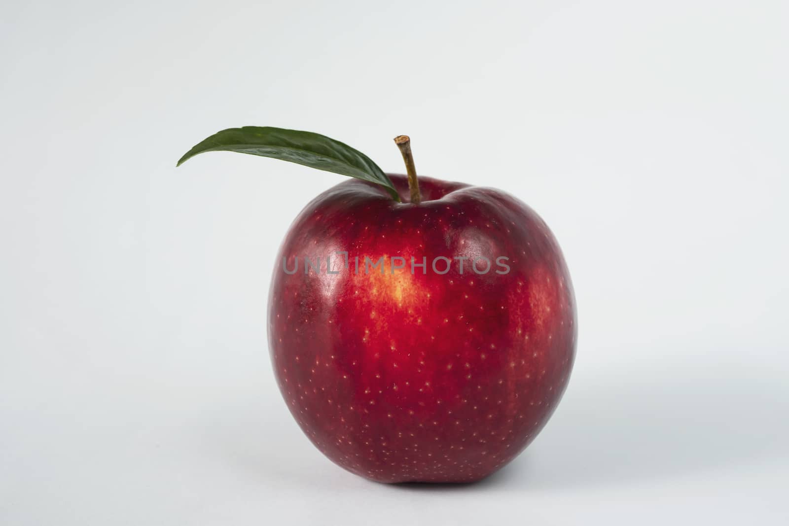 Fresh colorful apple over gray background - clean fresh fruit background concept by pairhandmade