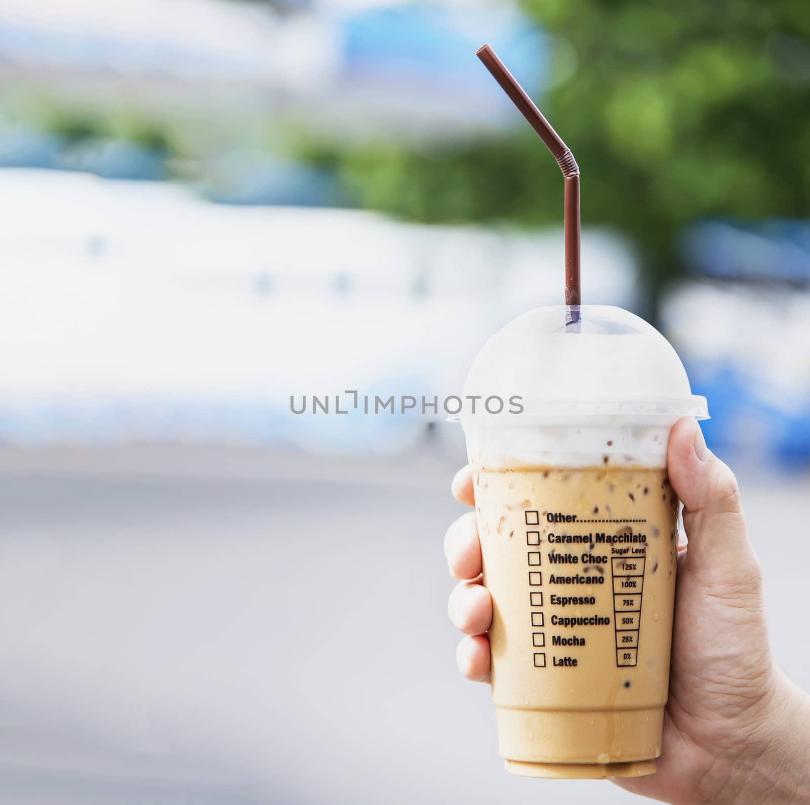 Hand showing fresh ice coffee cup - refreshment with ice coffee cup background concept by pairhandmade