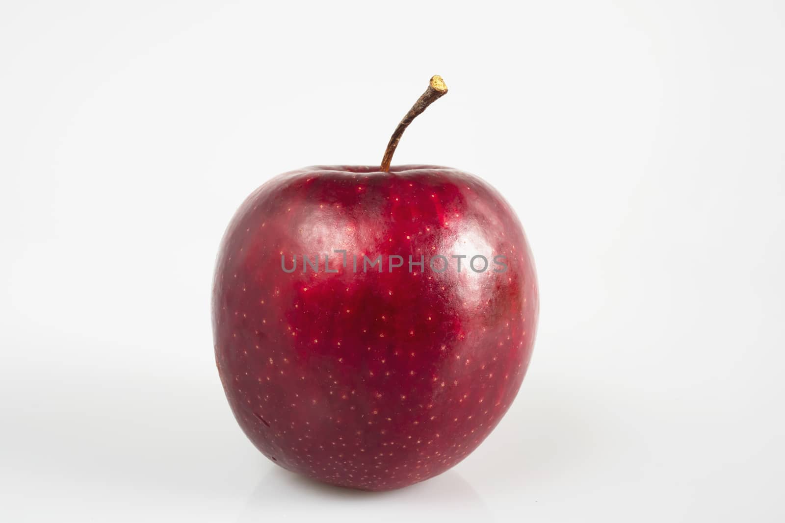 Fresh colorful apple over gray background - clean fresh fruit background concept