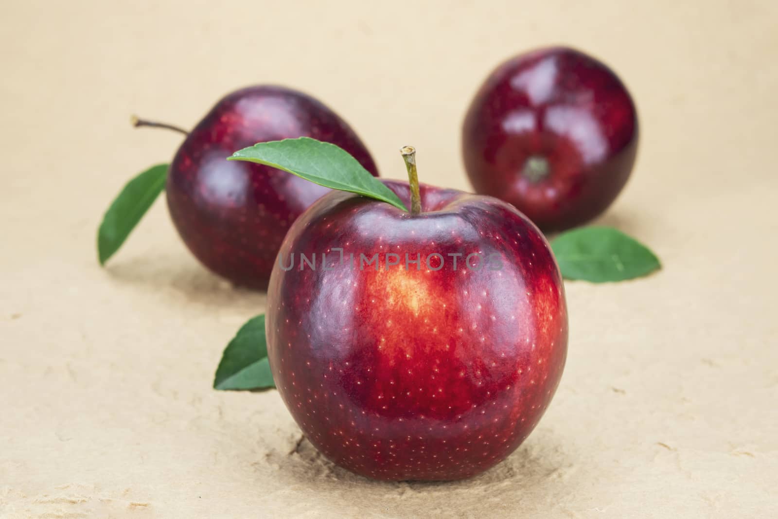 Fresh red apple over soft brown background - fresh fruit background concept