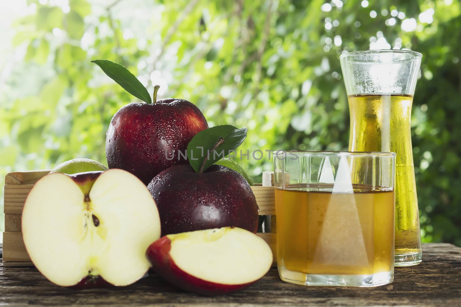 Fresh red apple with apple juice over white background - fresh fruit and juice product background concept