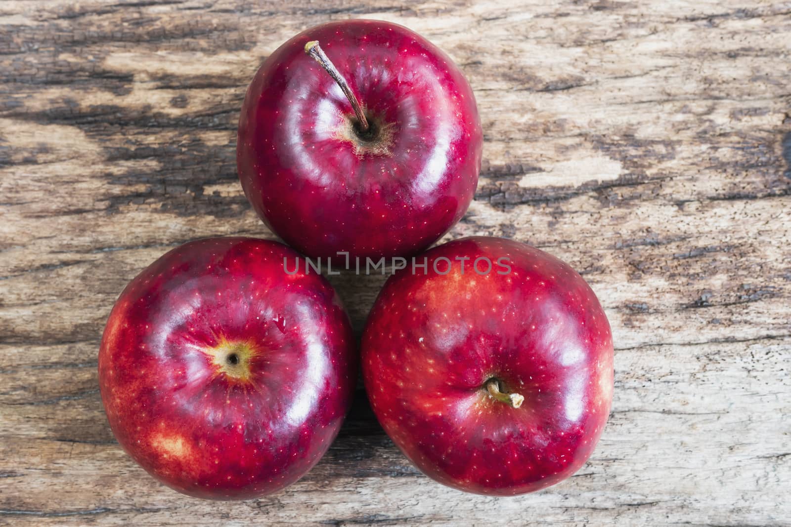 Fresh red apple over old wooden texture background - fresh fruit background concept