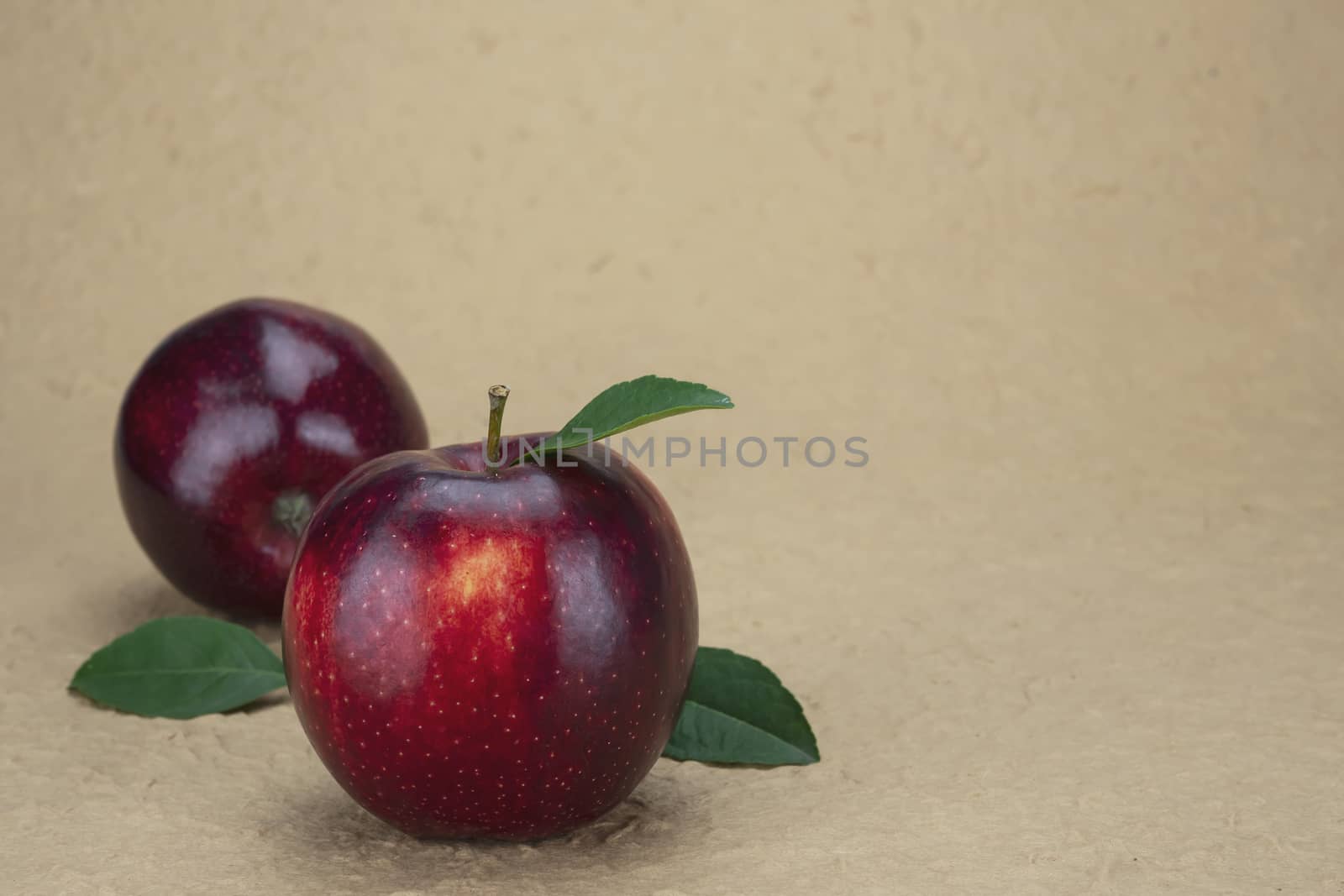 Fresh red apple over soft brown background - fresh fruit background concept