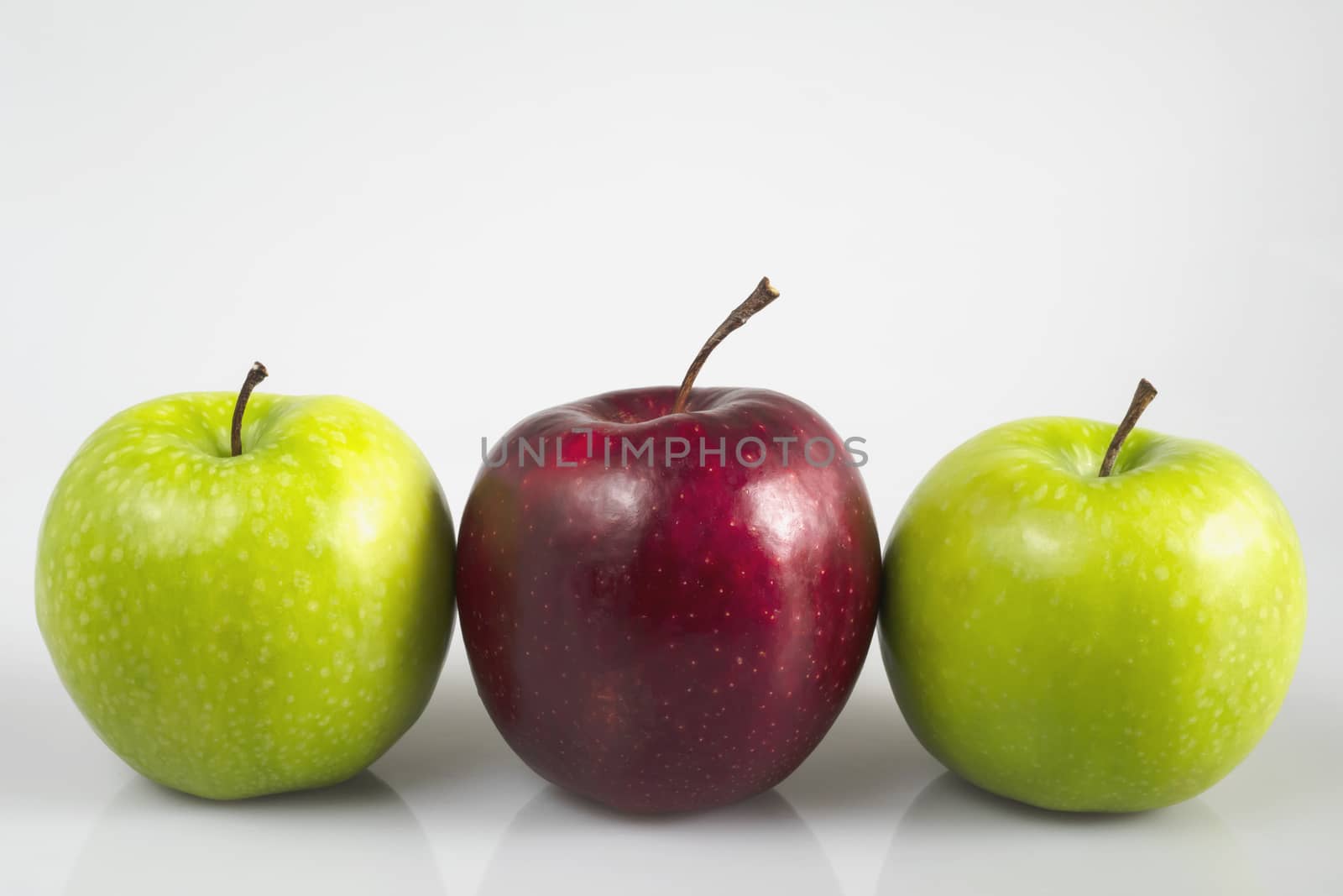 Fresh colorful apple over gray background - clean fresh fruit background concept