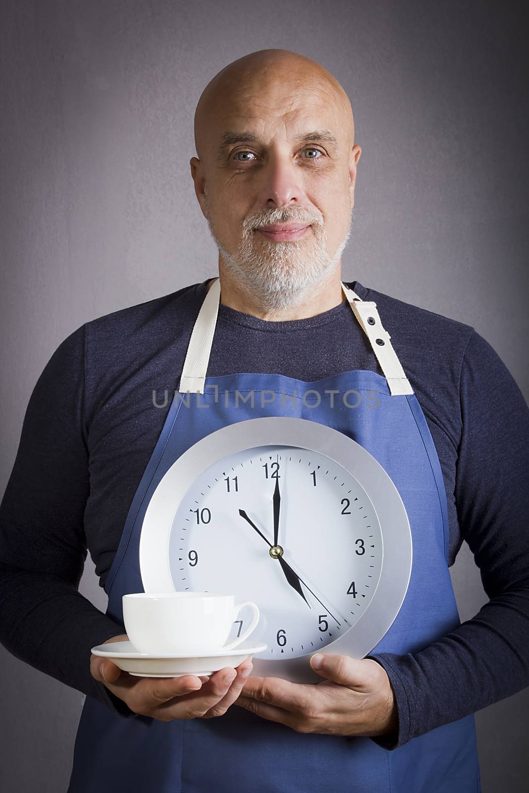 Five o'clock tea party concept. Man with a clock and a cup of tea