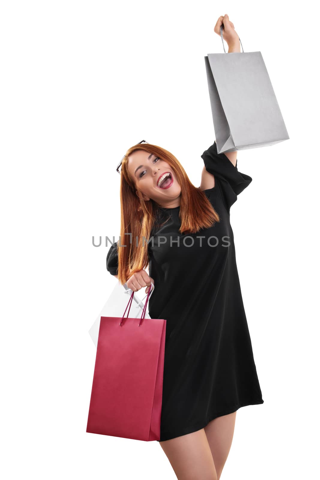 Excited and happy young woman with shopping bags by Mendelex