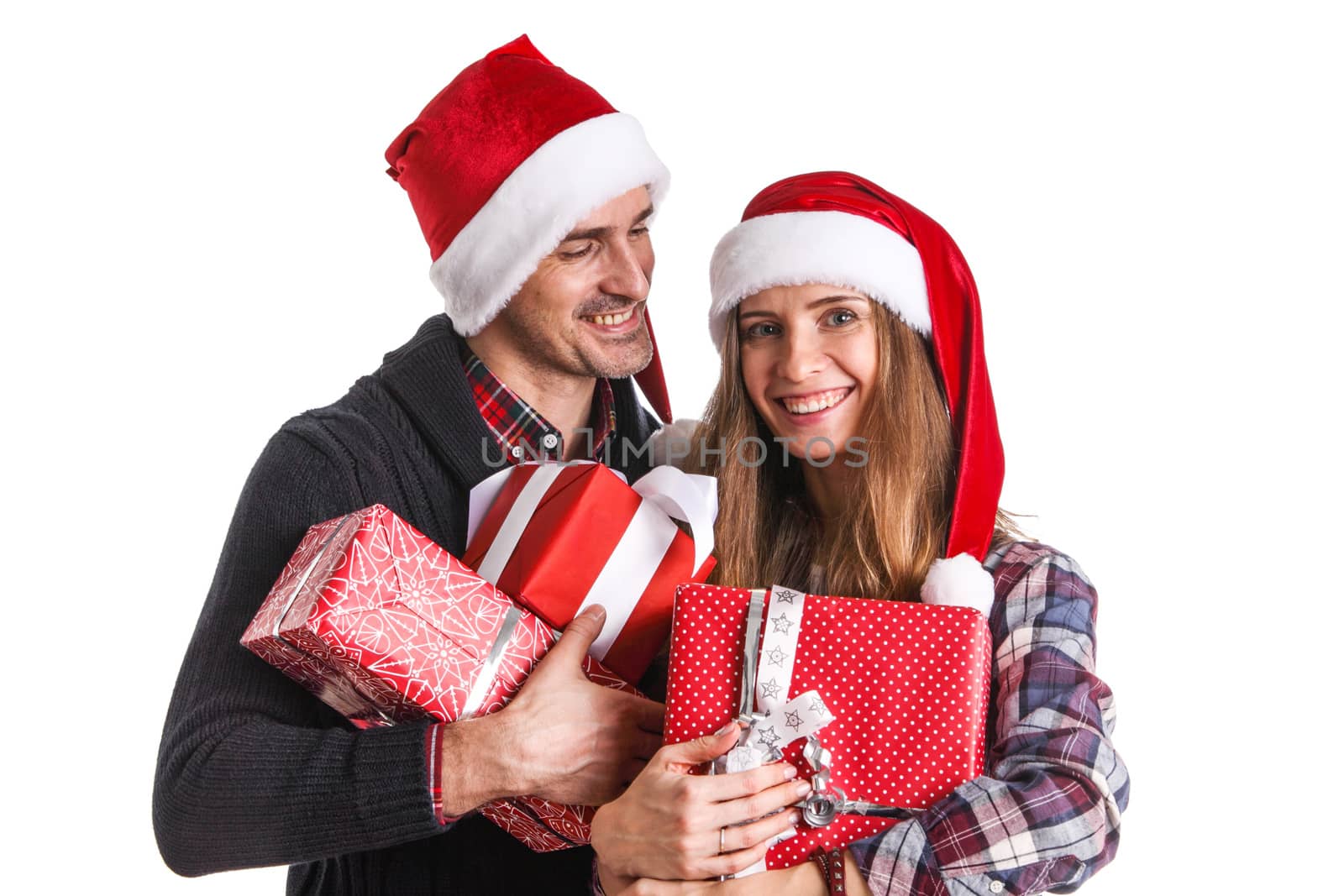 Happy beautiful couple holding many christmas gifts isolated on white background